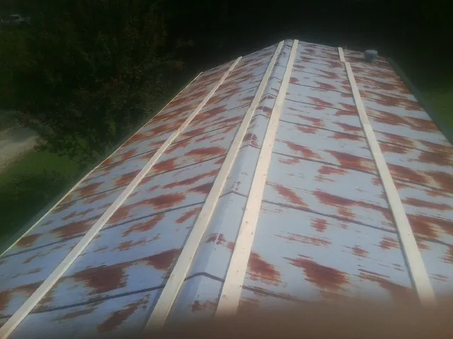 Rusted metal roof panels with new wood purlins before replacement — Storm Damage Roof Repair in Musselshell by Roofing Brothers