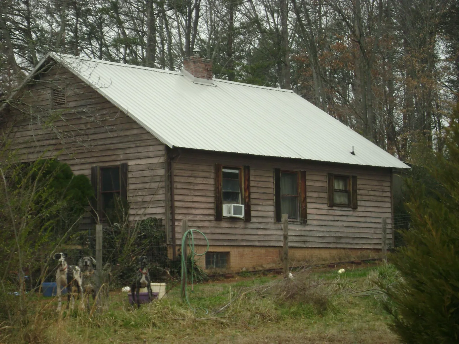 White metal roof on an old wood sided farmhouse, from a Metal Roof Installation job in Musselshell